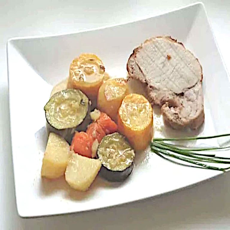 Rôti de porc au four aux légumes de saison, tranché dans sa cocotte avec courgettes, carottes et pommes de terre